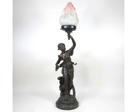 An early 20th century French Art Nouveau spelter table lamp, in the form a young lady holding aloft a torch, on a marble base