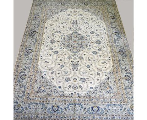 An early 20th century Kashan carpet, with all over foliate designs on a cream ground, 421 x 322cmOverall condition looks to b