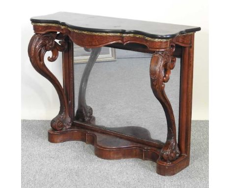 A 19th century carved walnut serpentine console table, with a marble top and mirrored back, on scrolled supports