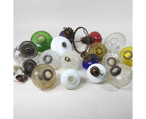 A collection of various coloured glass oil lamp fonts, to include peg oil lamp fontsYellow glass fitting measures 9cm wide. R