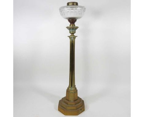 A n19th century brass oil lamp base, with a cluster stem, with a cut glass reservoir, on a stepped base, 59cm high
