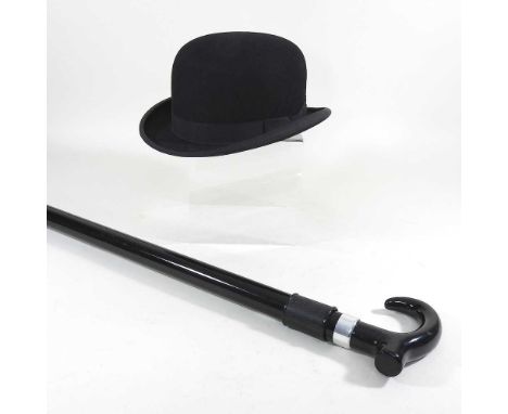 A bowler hat, by Christy's London, together with a walking stick, with a pop-out umbrella (2)