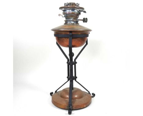 An Art and Crafts copper oil lamp base, on angular iron supports, in the manner of W A S Benson, with a Hink's burner, 46cm h