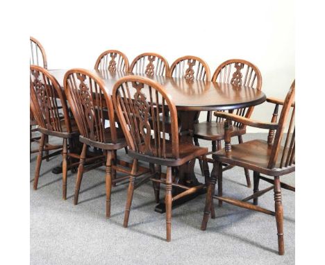 An Ercol extending refectory dining table, 210 x 88cm overall, together with ten wheel back dining chairs (11)