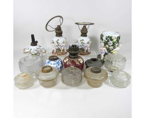 A collection of mainly 19th century glass oil lamp fonts and continental lamp bases