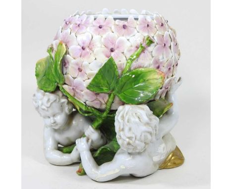 A Dresden style porcelain oil lamp base, late 20th century, with cherub supports, 21cm high