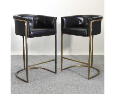 A pair of black leather upholstered bar stools, on brass supports (2)62w x 56d x 95h cmSome light signs of use and dirt, as t