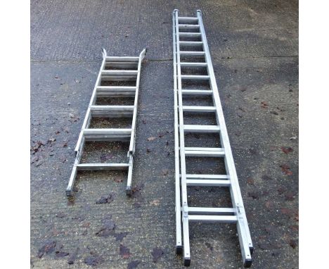 An aluminium extending ladder, in two sections, each 340cm long, together with another smaller (2)