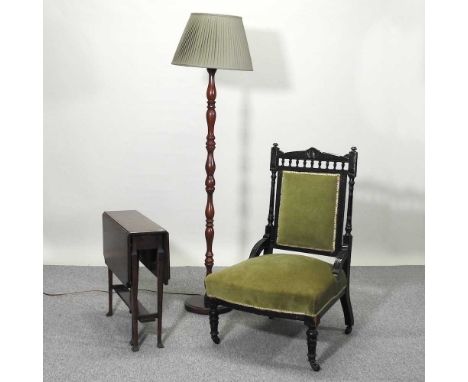 A Victorian ebonised and green upholstered chair, together with an early 20th century oak sutherland table and a modern stand