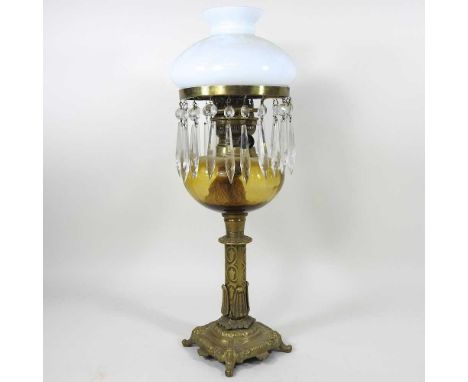 An ornate 19th century brass oil lamp, suspended with lustres, having an opaque white glass shade, 49cm high