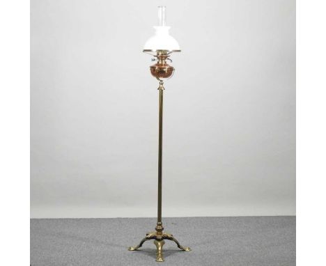 An Arts and Crafts telescopic oil lamp and shade, early 20th century, with a copper reservoir, on a petal base, 167cm high ov