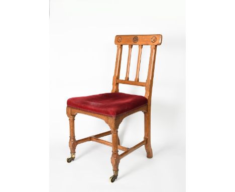 An oak side chair designed by Augustus Welby Northmore Pugin, chamfered decoration, on square legs, front legs with castors, 