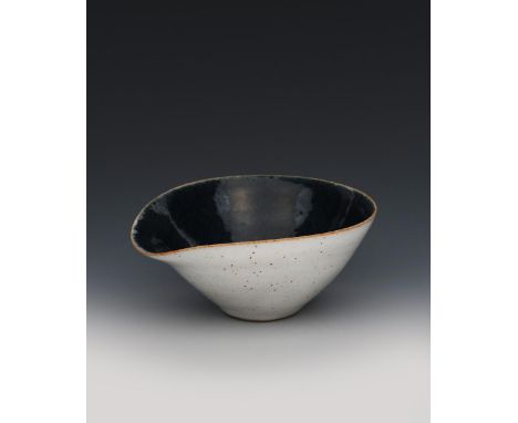 ‡Dame Lucie Rie (1902-1995) a stoneware pouring bowl, white glaze with tan specks to the exterior, the interior and base glaz