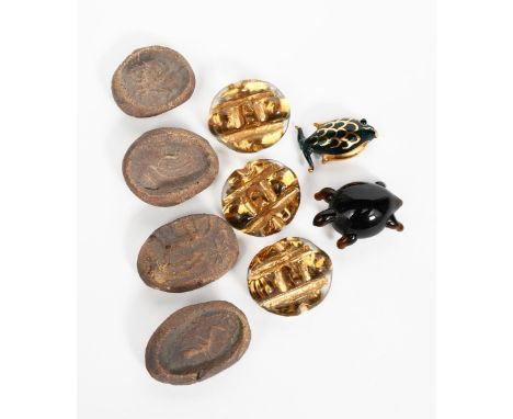 ‡Bimini Glass Ltd A set of three glass buttons, oval with cast decoration and gold highlights, with brass mount, a glass tort