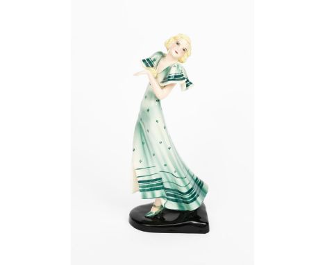 A Goldscheider Pottery model of a lady by Stephan Dakon, model no.6940, modelled standing in low flowing green dress, impress