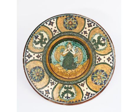 An Art Nouveau wall charger probably Della Robbia Pottery,  incised to the well with an angel flying above clouds, the rim wi