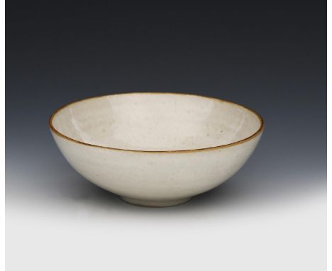 ‡Dame Lucie Rie (1902-1995) and Hans Coper (1920-1981) a stoneware bowl, circular section, covered in a pitted, white glaze i