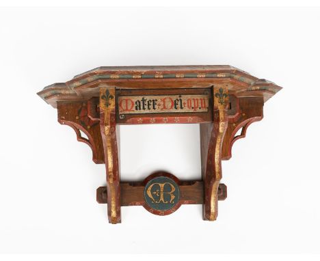 A Gothic Revival painted oak wall bracket in the manner of A W N Pugin, shaped top over buttress with pierced tracery edges, 