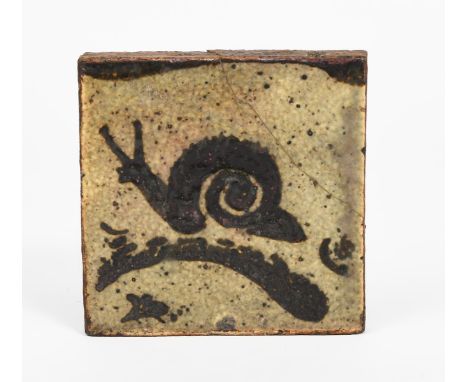 ‡Bernard Leach CBE (1887-1979) a Leach Pottery stoneware tile, painted with a snail on a thin leaf, in tenmoku on a mottled b