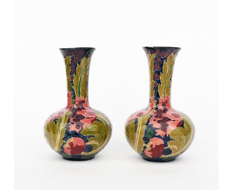 A pair of Bursley Ware Pottery Seed Poppy vases designed by Charlotte Rhead, ovoid with flaring necks, painted in shades of p