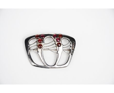 A Murrle Bennett silver and garnet brooch the design attributed to Max Gradl,  pierced and cast with stylised Secessionist fo