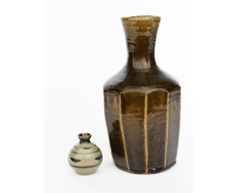 ‡Trevor Corser (1938-2015), attributed a Leach Pottery cut sided vase with cylindrical neck, covered in an olive green glaze 