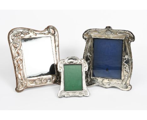 An Art Nouveau English silver photograph frame by William Neale, shaped rectangular form, stamped in low relief with kingfish
