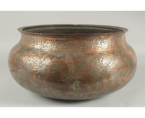 A LARGE 17TH CENTURY TINNED COPPER BASIN, with calligraphy and engraved fish decoration, possibly Deccani or Safavid Persian,