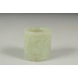 AN EARLY 20TH CENTURY CHINESE CARVED JADE RING, 3.5cm long.