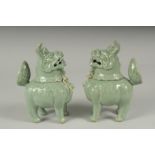 A PAIR OF CHINESE CELADON GLAZED PORCELAIN FIGURAL CENSER BURNERS, in the form of mythical beasts