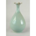 A CHINESE CELADON GLAZE PORCELAIN VASE, with stylised petal-formed rim, 27cm high.