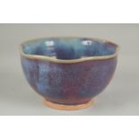 A CHINESE JUN WARE PORCELAIN BOWL, with wavey rim, 16.5cm wide.