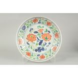 A CHINESE SANCAI LOTUS PORCELAIN CHARGER, 33cm diameter.