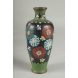 A BLACK GROUND CLOISONNE VASE, with decorative floral roundels and green scale pattern, 21.5cm