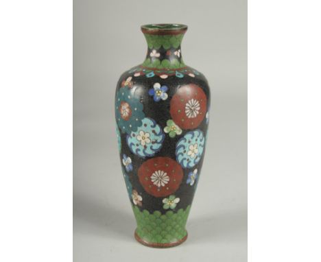 A BLACK GROUND CLOISONNE VASE, with decorative floral roundels and green scale pattern, 21.5cm high.