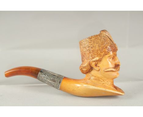 AN UNUSUAL 19TH CENTURY MERCHEUM PIPE depicting Persian Qajar King Nasir Aldeen Qajar, with amber mouth piece, 10cm long.