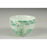 A CHINESE FAMILLE VERTE PORCELAIN CUP, decorated with bamboo, character mark to base. 6cm diameter.