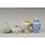 FOUR CHINESE MINIATURE POTTERY PIECES, including a small Hoi An Hoard shipwreck cargo pot, a famille