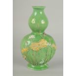 AN EARLY 20TH CENTURY CHINESE GREEN GROUND DOUBLE GOURD WALL VASE, with relief decoration, 21cm