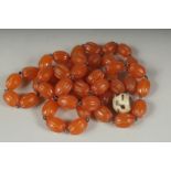 AN EARLY 20TH CENTURY AMBER BEADED NECKLACE AND DZI BEAD, (2).