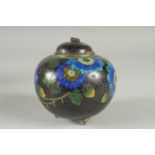 A BLACK GROUND CLOISONNE JAR AND COVER, with glittered enamel flowers, 11cm high.
