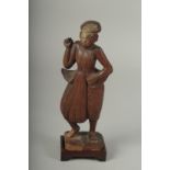 A CHINESE CARVED WOOD FIGURE AND STAND.