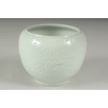 A CHINESE REPUBLIC PERIOD WHITE CELADON PORCELAIN POT, with carved ruyi stylised foliate decoration,