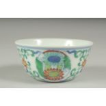 A CHINESE DOUCAI PORCELAIN CUP, decorated with floral motifs, character mark to base, 8cm diameter.