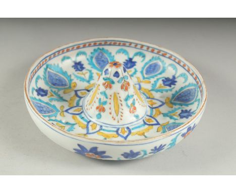 A TURKISH KUTAHYA GLAZED POTTERY LEMON SQUEEZER, 18.5cm diameter.
