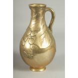 A JAPANESE BRASS JUG, with relief foliate decoration, 23cm high.