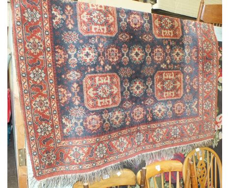 A modern flat-weave tapestry wall hanging with central female figure surrounded by flowers, 146 x 335cm and two modern rugs, 