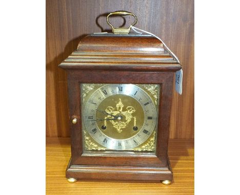 A modern stained mahogany case striking mantel clock, 27cm high, 17cm wide.