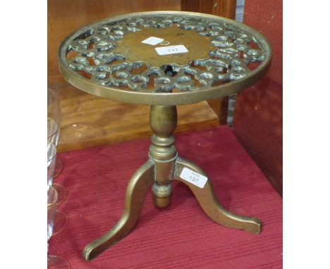 A heavy brass trivet, the pierced circular top on tripod support, 27.5cm diameter, 28cm high.