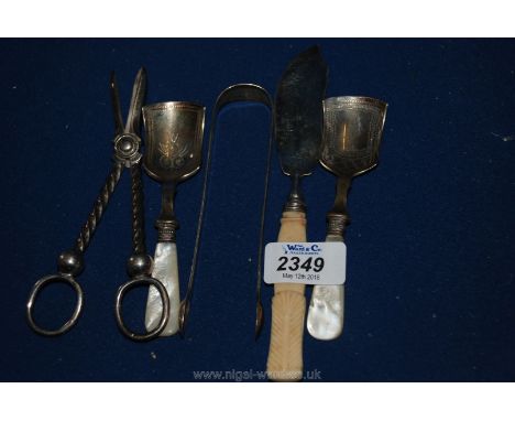 A Silver butter knife, sugar tongs, silver plated caddy spoons and wick trimmers